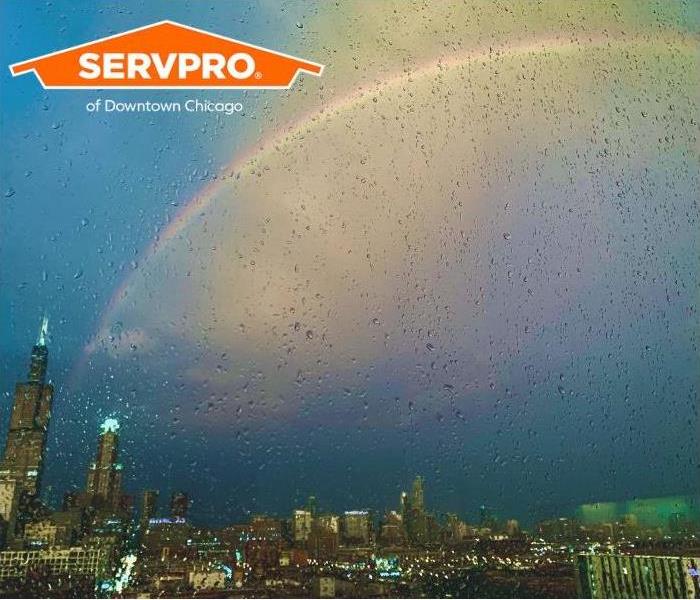 A summer thunderstorm and a rainbow are seen over Downtown Chicago.