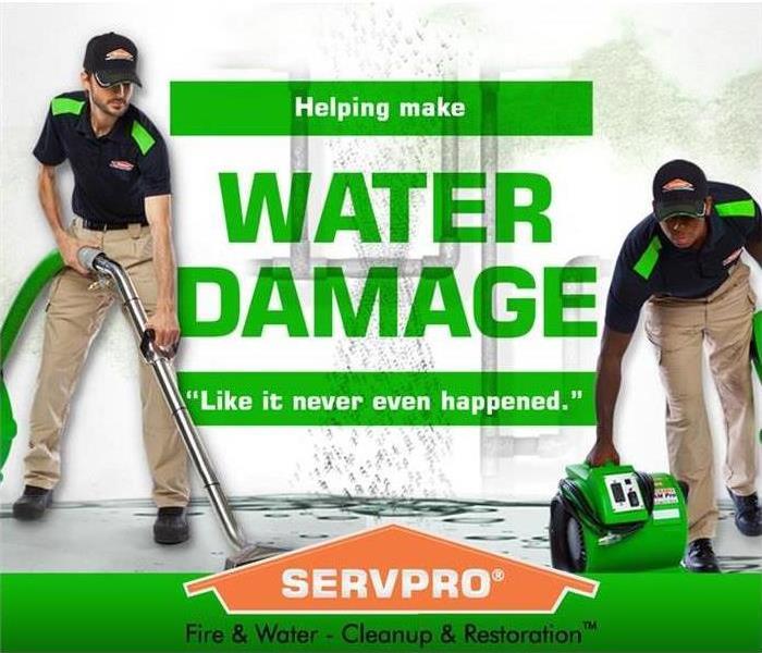 Two SERVPRO technicians with water damage and the SERVPRO orange house.